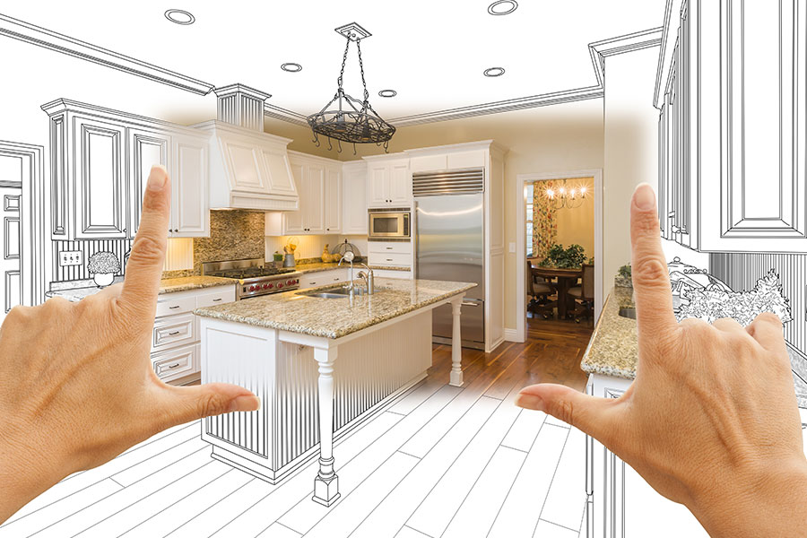 Person holding up their hands and fingers while imagining a Sprignfield Illinois home remodeling design over a while project blueprint.