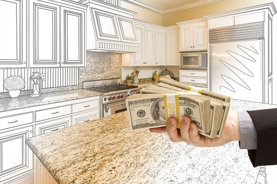 Main in a black suit holding up wads of one-hundred-dollar bills in front of a kitchen remodeling design in Springfield, IL.
