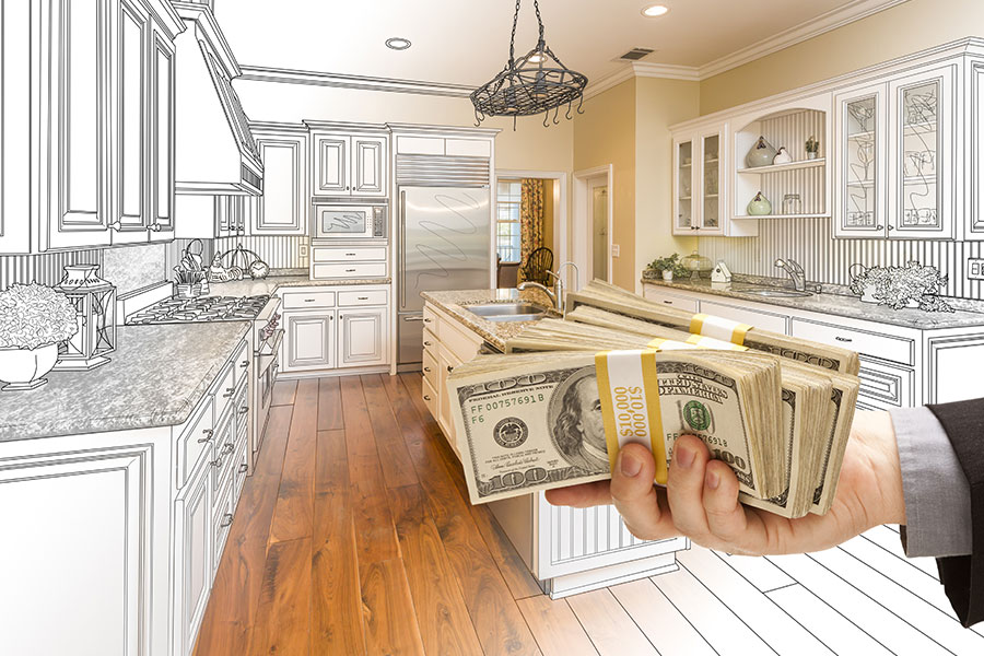 Man holding money in a kitchen to finance a Springfield IL kitchen remodel job done by a small business home improvement company