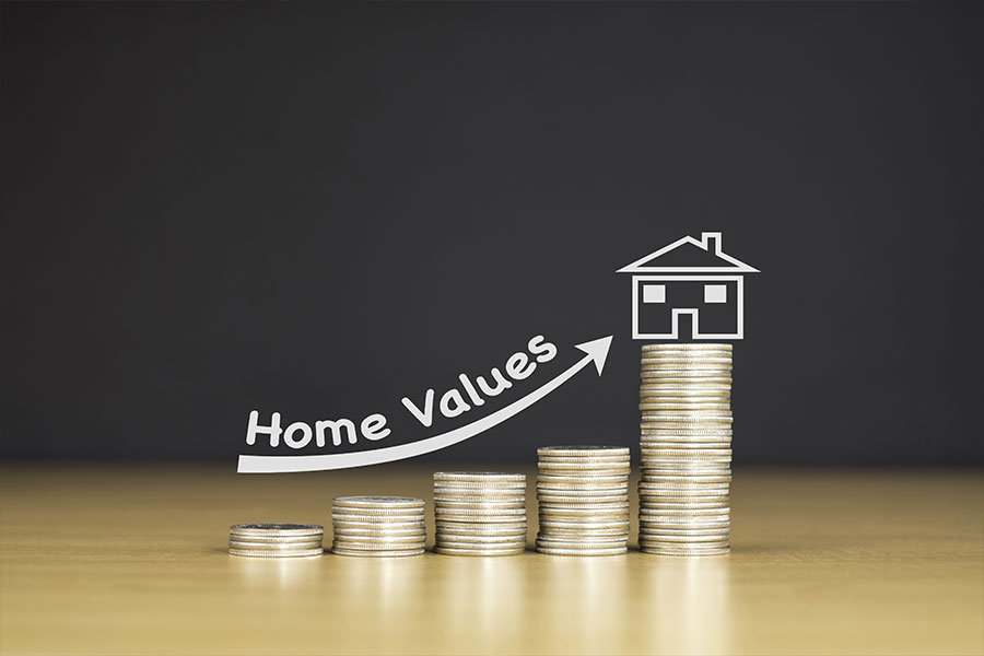 An increase in a homes value represented on a stack of coins. The homes value increased with the help of a home improvement company in Springfield, IL.