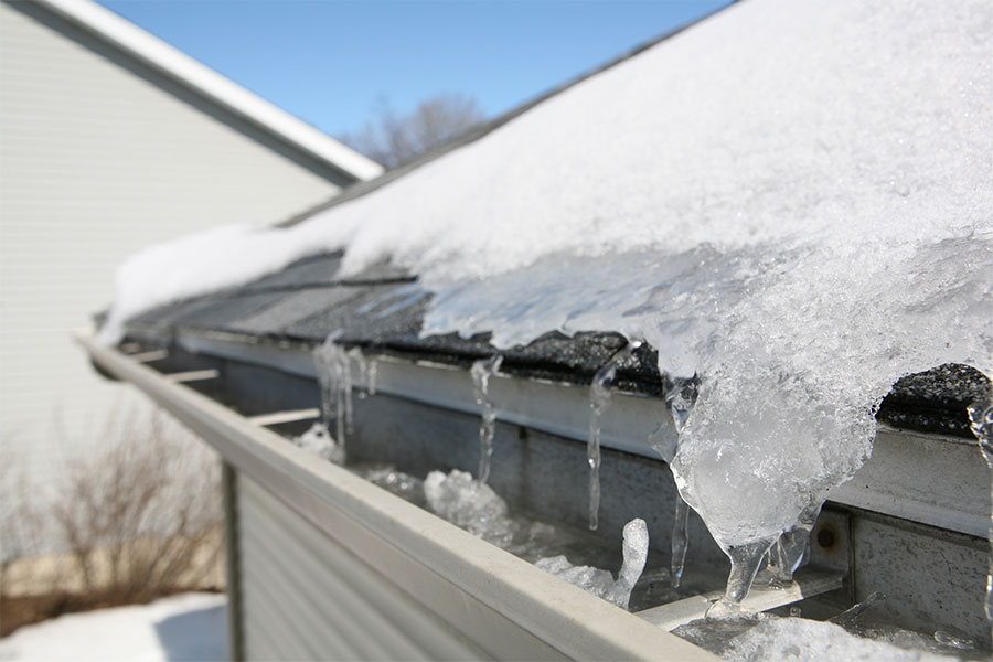 Snow and ice on a roof causing damage that requires repairs from a home improvement company in Springfield, Illinois.