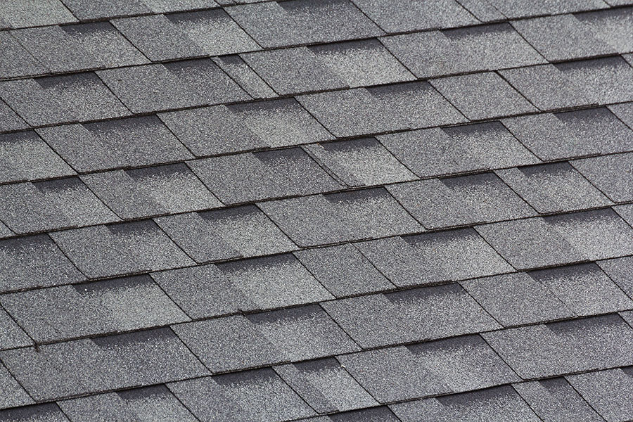 Shingles that need to be inspected by a home improvement company in Springfield, IL after a severe storm.