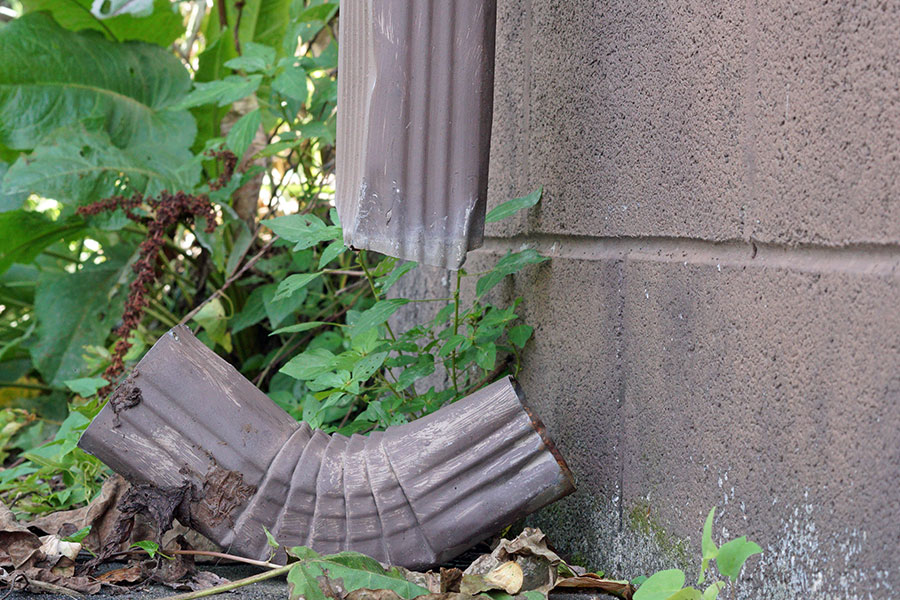 A broken downspout that is creating flooding issues on a residential property in Springfield, IL.