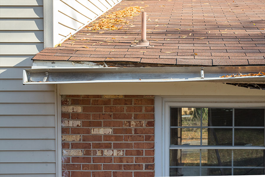 A residential home in Springfield, IL with a broken gutter handing away from the home and needing to be replaced.