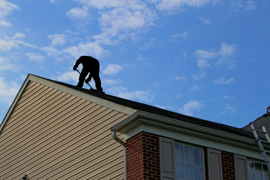 image of a roofing contractor repairing a roof in Springfield IL