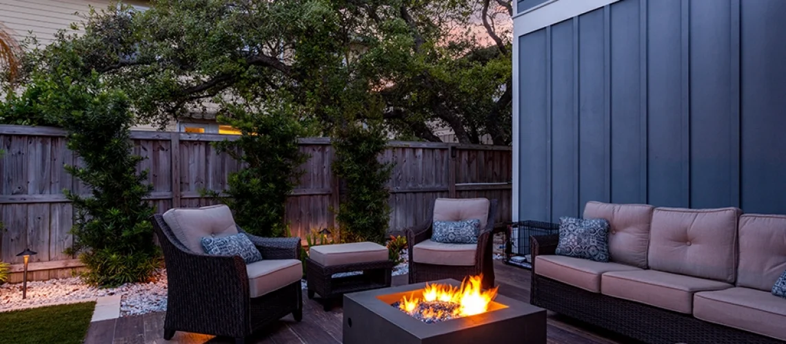 Modern outdoor furniture and a fireplace on the deck of a home in Springfield, IL.